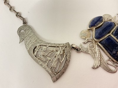Lot 14 - Egyptian white metal and blue stone scarab beetle pendant necklace with pierced and carved white metal panels depicting birds and Egyptian figures