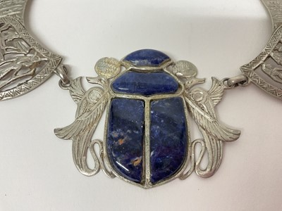 Lot 14 - Egyptian white metal and blue stone scarab beetle pendant necklace with pierced and carved white metal panels depicting birds and Egyptian figures