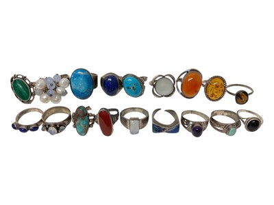 Lot 16 - Eighteen silver / white metal rings set with semi-precious stones including turquoise, amber, lapis lazuli, moonstone etc