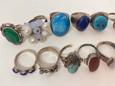 Lot 16 - Eighteen silver / white metal rings set with semi-precious stones including turquoise, amber, lapis lazuli, moonstone etc