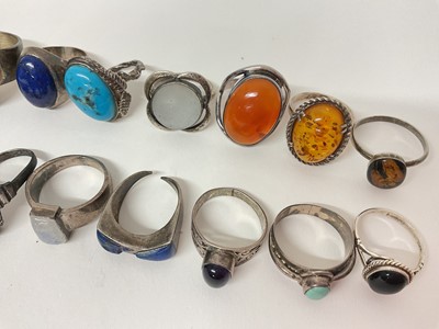 Lot 16 - Eighteen silver / white metal rings set with semi-precious stones including turquoise, amber, lapis lazuli, moonstone etc