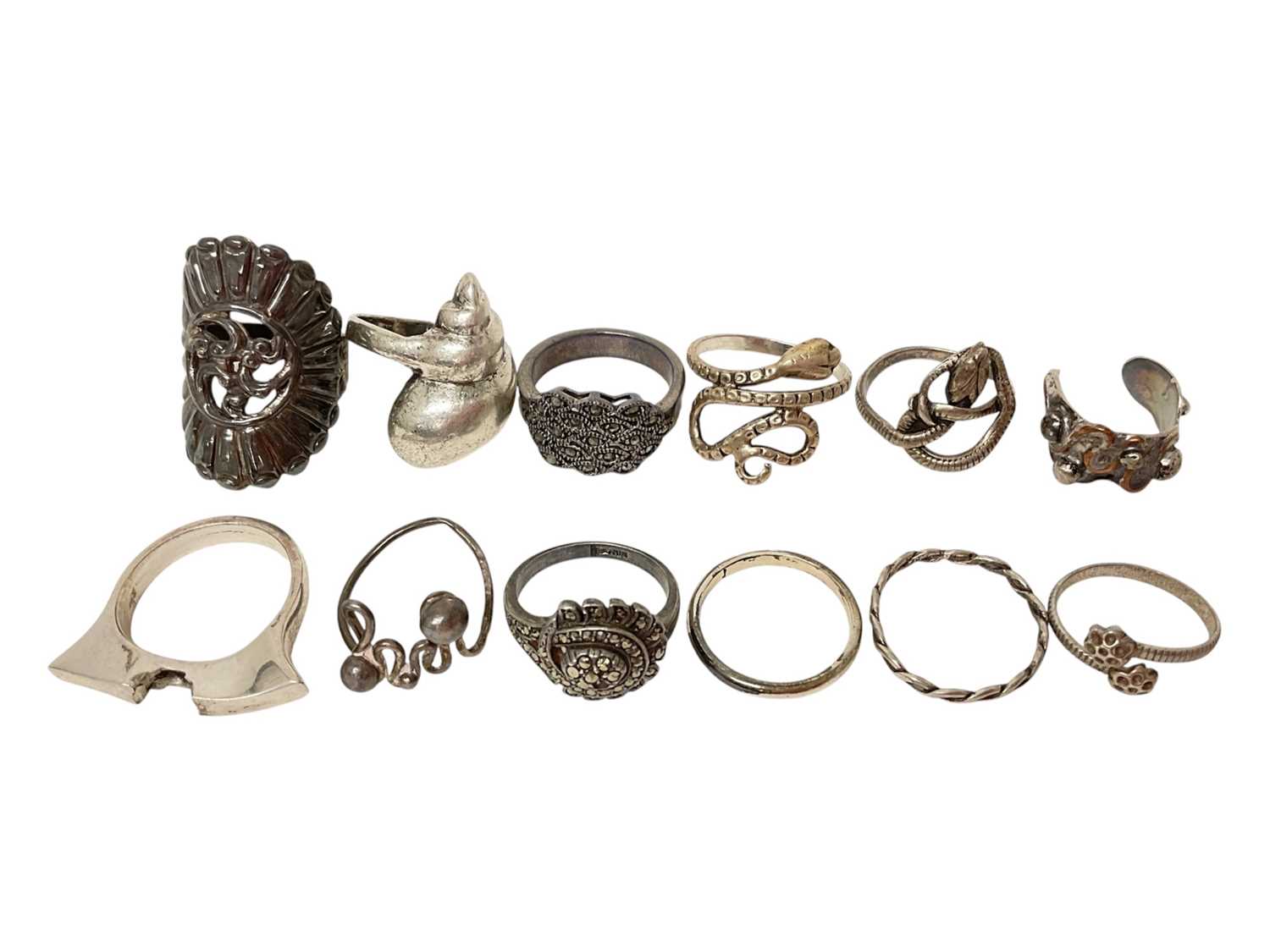 Lot 18 - Twelve silver / white metal rings including marcasite, two coiling snake rings, shell ring etc