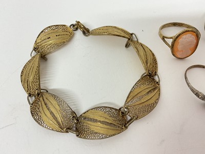 Lot 19 - Continental silver gilt (800) ram's head ring with wrap around scroll design shank, silver gilt filigree panel bracelet and three other rings