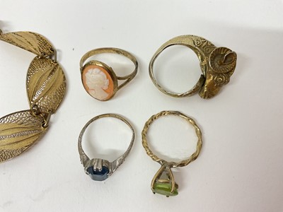 Lot 19 - Continental silver gilt (800) ram's head ring with wrap around scroll design shank, silver gilt filigree panel bracelet and three other rings