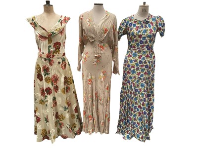 Lot 2527 - 1940s and 50s dresses including floral evening dress with gathered bodice, floral evening dress, gathered neckline, tulips sleeves and full skirt, black cocktail dress, stiffened skirt and lar...