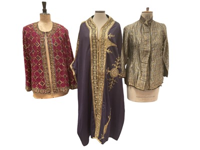 Lot 2528 - Purple wool kaftan with gold braiding, paisley print jacket, black velvet embroidered evening coat, silk jacket with sequinnes in geometric pattern, red wool crepe coat dress and two chiffon top...