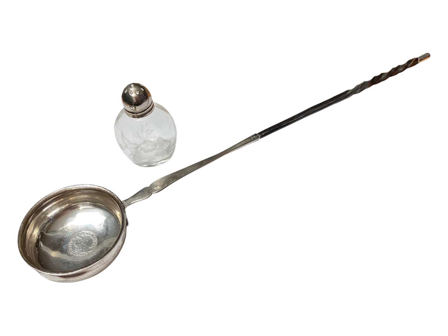 Lot 17 - Georgian silver toddy ladle with a coin inset and a twisted whalebone handle and a glass pepperette with plated mount (2)