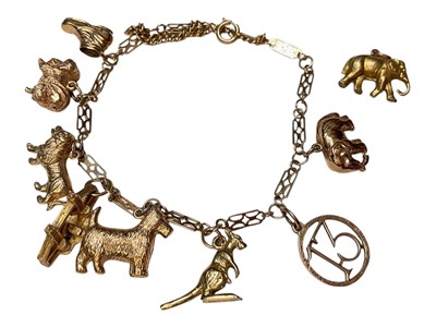 Lot 21 - 9ct gold fancy link charm bracelet with eight 9ct gold novelty charms and a loose gilt metal elephant charm