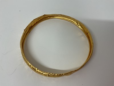 Lot 21 - Eastern 22ct gold bangle with engraved decoration