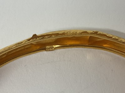 Lot 21 - Eastern 22ct gold bangle with engraved decoration