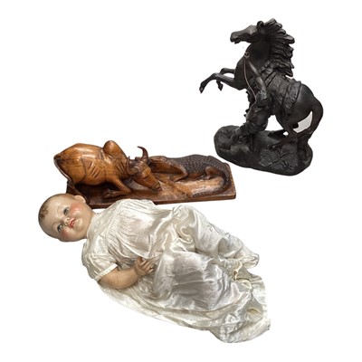 Lot 5181 - Resin equestrian sculpture, together with a wooden carving of a bull and a crocodile, and a composite doll (3)
