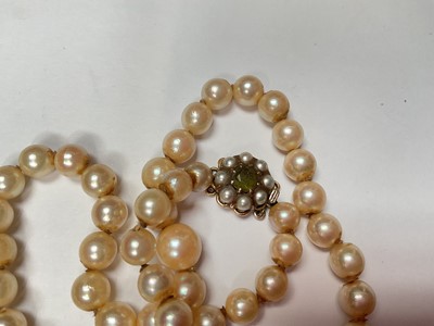 Lot 117 - Cultured pearl single string necklace with a 9ct gold seed pearl and peridot flower head cluster clasp, 41.5cm long