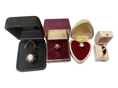 Lot 118 - 9ct gold opal and sapphire cluster ring, 9ct gold synthetic single stone ring, 9ct gold seed pearl and garent flower head cluster ring, 9ct gold v-shaped ring and a black enamel gold plated dres...