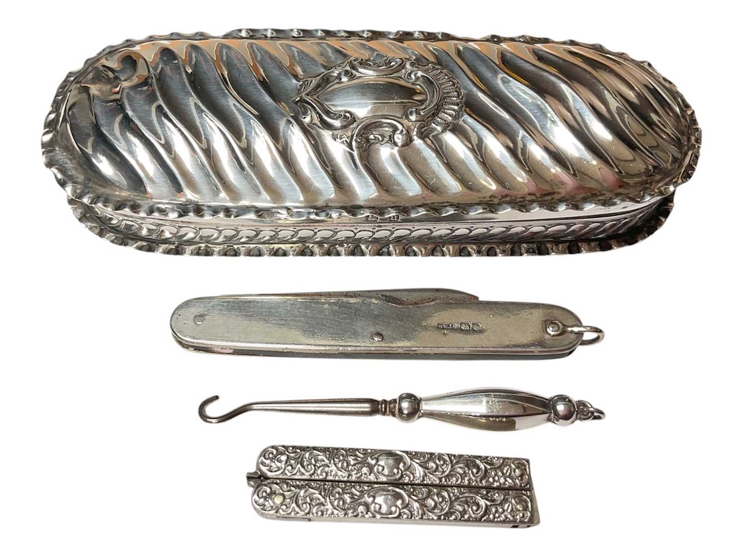 Lot 127 - Victorian silver dressing table box (Birmingham 1894) containing a pair of silver mounted folding sewing scissors, silver mounted penknife and a silver handled button hook