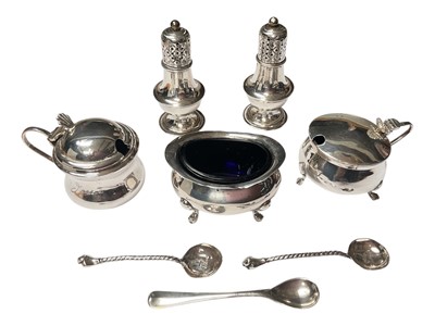 Lot 131 - Silver three piece condiment set with blue glass liners, five various silver salt spoons and a pair of silver pepperettes