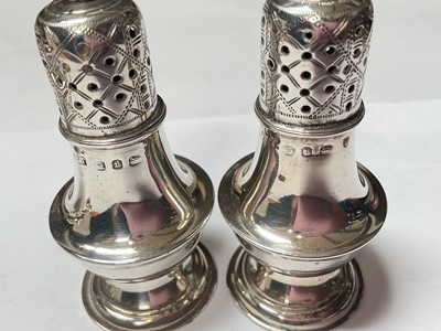Lot 131 - Silver three piece condiment set with blue glass liners, five various silver salt spoons and a pair of silver pepperettes