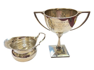Lot 132 - Edwardian silver cream jug and a 1920s silver two handled trophy with presentation engraving