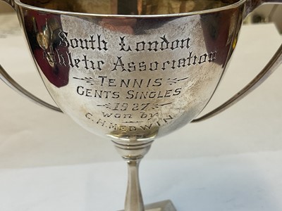 Lot 132 - Edwardian silver cream jug and a 1920s silver two handled trophy with presentation engraving