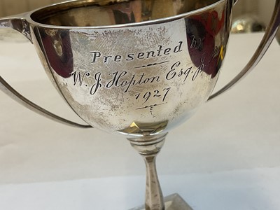 Lot 132 - Edwardian silver cream jug and a 1920s silver two handled trophy with presentation engraving