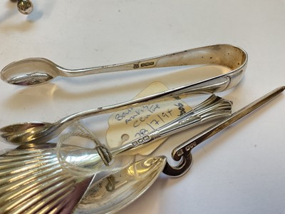 Lot 133 - Group of silver to include a tea strainer, Edwardian caddy spoon, pair of sugar tongs, coffee spoon and a pair of knife rests