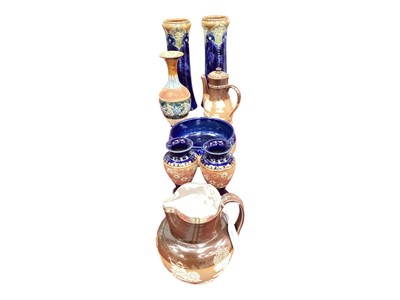 Lot 2213 - Collection of Royal Doulton to include a tall pair of Art Nouveau vases, three other vases, harvest ware jug and coffee pot and a fruit bowl (8)