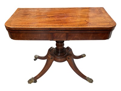 Lot 5339 - Regency mahogany cross banded card table with baluster column, outswept legs with brass paw feet and casters, 91.5cm wide x 45cm deep x 73.5cm high