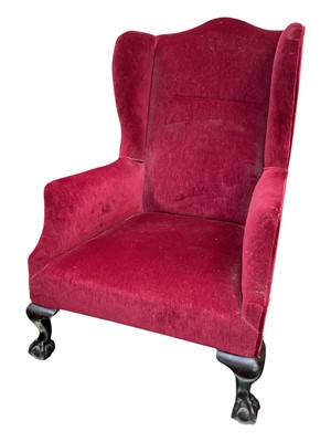 Lot 5346 - Wing back armchair with red velvet upholstery, early 20th century, with claw and ball feet, 114cm high