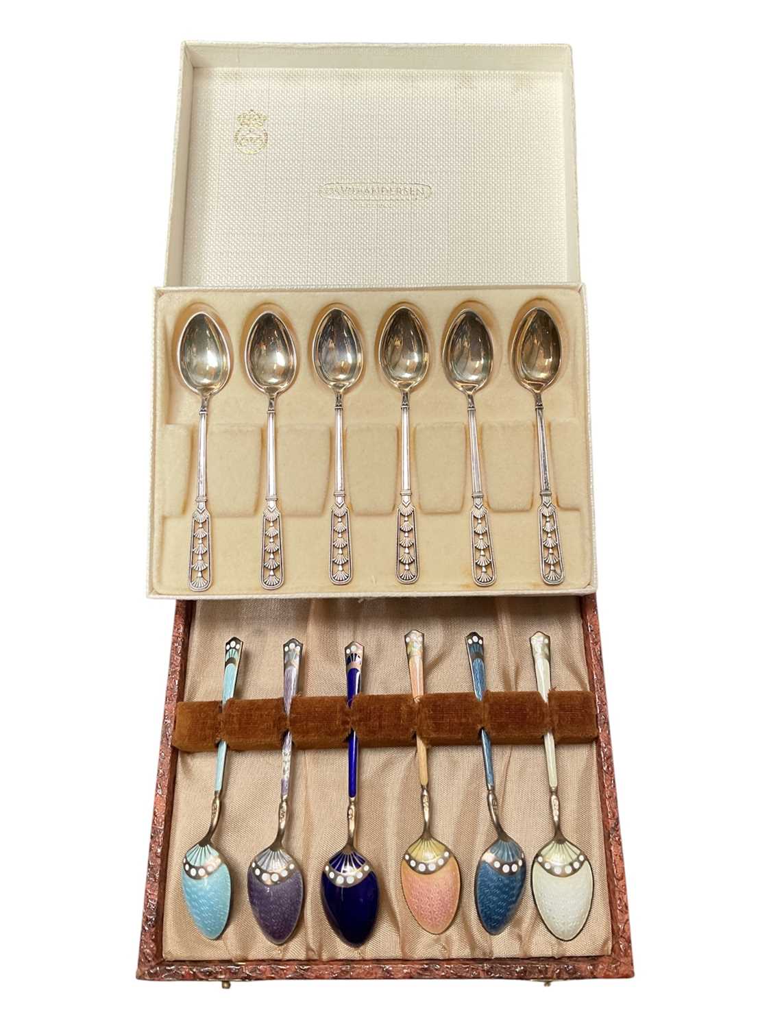 Lot 39 - Set of six David Andersen Norwegian silver coffee spoons with pieced decoration in original box, together with a set of six silver and enamel coffee spoons in case
