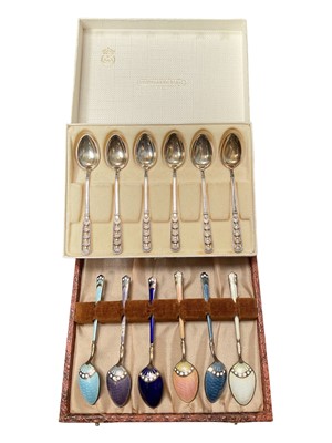 Lot 39 - Set of six David Andersen Norwegian silver coffee spoons with pieced decoration in original box, together with a set of six silver and enamel coffee spoons in case