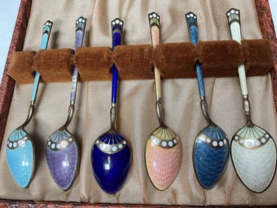 Lot 39 - Set of six David Andersen Norwegian silver coffee spoons with pieced decoration in original box, together with a set of six silver and enamel coffee spoons in case