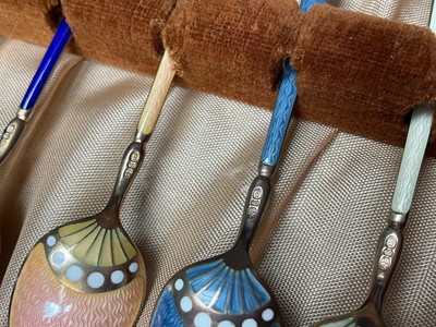 Lot 39 - Set of six David Andersen Norwegian silver coffee spoons with pieced decoration in original box, together with a set of six silver and enamel coffee spoons in case