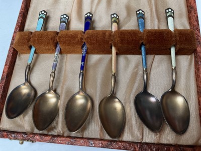 Lot 39 - Set of six David Andersen Norwegian silver coffee spoons with pieced decoration in original box, together with a set of six silver and enamel coffee spoons in case