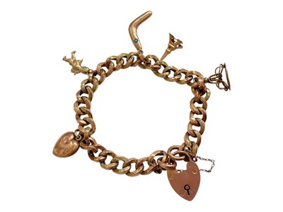 Lot 77 - 9ct gold curb link charm bracelet with alternating textured links, five 9ct gold / yellow metal charms and a padlock clasp