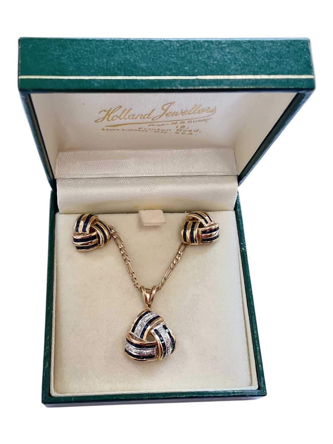 Lot 79 - 9ct gold sapphire and diamond three panel cross-over pendant on 9ct gold flat curb link chain, together with a pair of similar design 9ct gold sapphire stud earrings