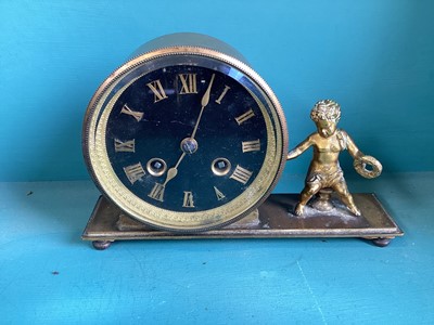 Lot 5003 - Antique brass mantel clock, the black dial with Roman numerals, a seated cherub next to the clock, striking on a bell