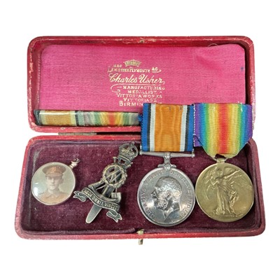 Lot 702 - First World War medal pair comprising War and Victory medals named to 269386. PTE. C. H. Dobson. Labour Corps, together with a cap badge and 9ct gold mounted glazed locket containing military po...