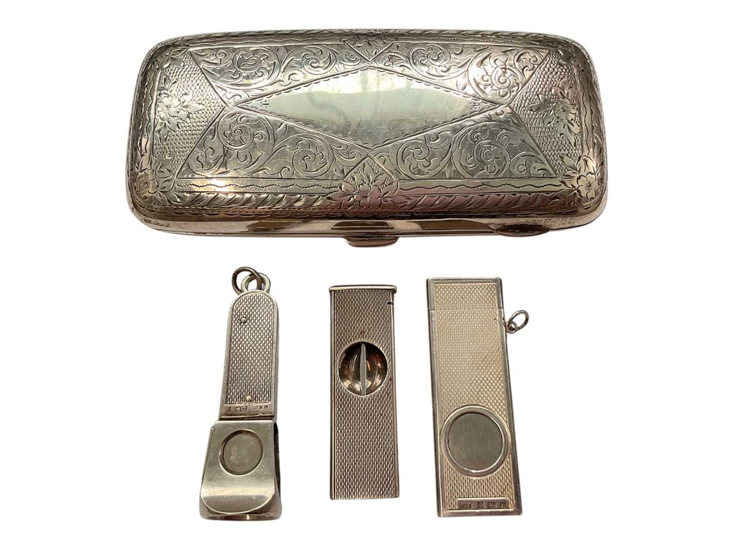 Lot 143 - Edwardian silver cigar case with engraved scroll decoration (Birmingham 1904), together with three silver mounted cigar cutters