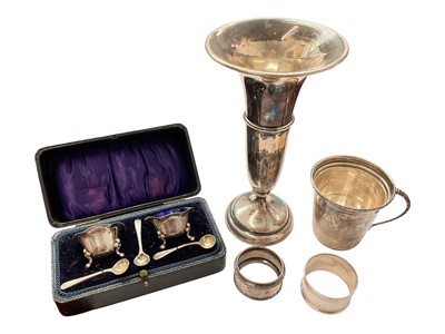 Lot 144 - Group of silver to include a pair of salts with three salt spoons in fitted case, two napkin rings, 1940s cup and a 1920s spill vase with weighted base