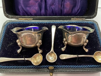 Lot 144 - Group of silver to include a pair of salts with three salt spoons in fitted case, two napkin rings, 1940s cup and a 1920s spill vase with weighted base