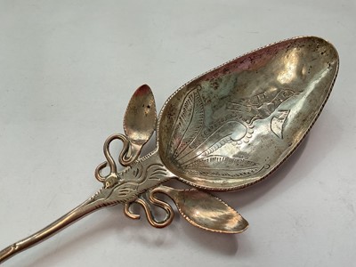 Lot 145 - Eastern white metal pot and cover with enrgaved foliate scroll decoration, Eastern white metal serving spoon, two silver (830) napkin rings, a plated napkin ring and a silver (830) fork