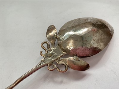 Lot 145 - Eastern white metal pot and cover with enrgaved foliate scroll decoration, Eastern white metal serving spoon, two silver (830) napkin rings, a plated napkin ring and a silver (830) fork