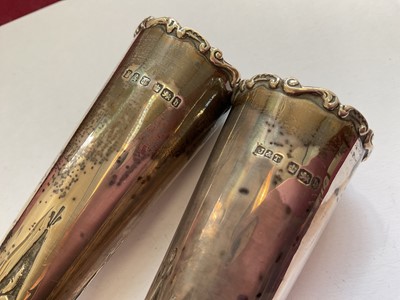 Lot 84 - Pair of late Victorian silver spill vases with embossed foliate scroll decoration, another pair of silver spill vases and a pair for silver candlesticks