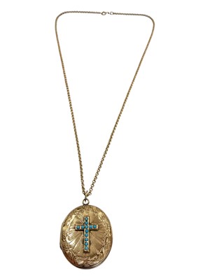 Lot 104 - Victorian gilt metal oval locket with a turquoise set cross and engraved scroll decoration, on a 9ct gold chain