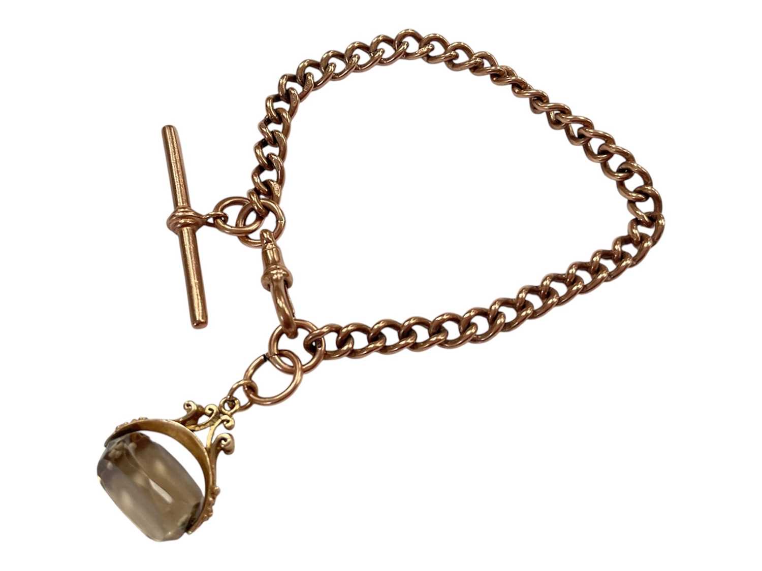Lot 105 - 9ct rose gold watch chain bracelet (London 1990) with a 9ct gold mounted smoky quartz rotating fob