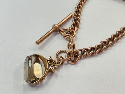 Lot 105 - 9ct rose gold watch chain bracelet (London 1990) with a 9ct gold mounted smoky quartz rotating fob