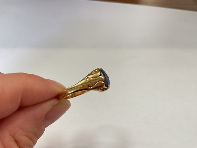 Lot 113 - Yellow metal single blue single stone ring