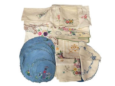 Lot 2545 - Box of large white damask tablecloths, other tablecloths, embroidered mats, and small tablecloths. Plus a few children's nighties.