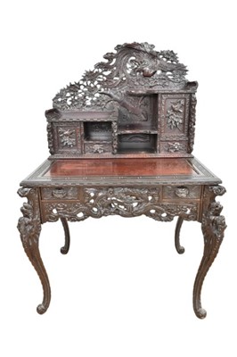 Lot 1354 - Late 19th century Japanese Meiji period carved wooden desk in two sections, elaborately carved with pheonix and dragons, bird and flowers. 100cm wide x 145cm high x 72cm deep