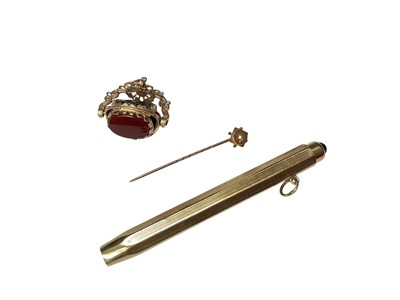 Lot 81 - 9ct gold rotating seal fob, Victorian 9ct gold seed pearl stick pin and a yellow metal propelling pencil with a blue cabochon finial (3)