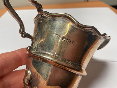 Lot 102 - 1960s silver sugar caster, silver cream jug, Edwardian silver napkin ring, pair of Victorian silver sugar tongs and an Edwardian silver cased pocket watch (5)